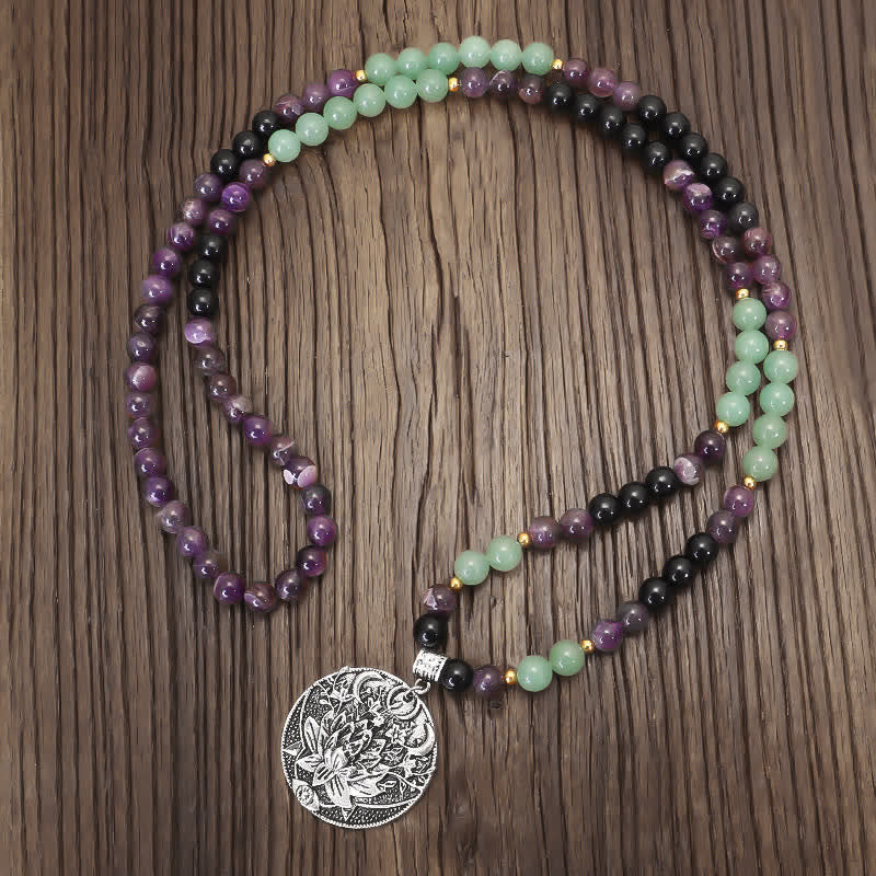 Amethyst Aventurine Lotus Mala - Color-block gemstone necklace with lotus medallion on dark wood grain