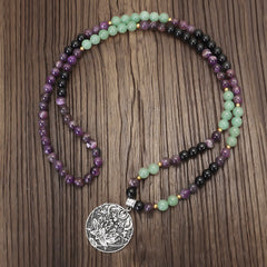 Amethyst Aventurine Lotus Mala - Color-block gemstone necklace with lotus medallion on dark wood grain