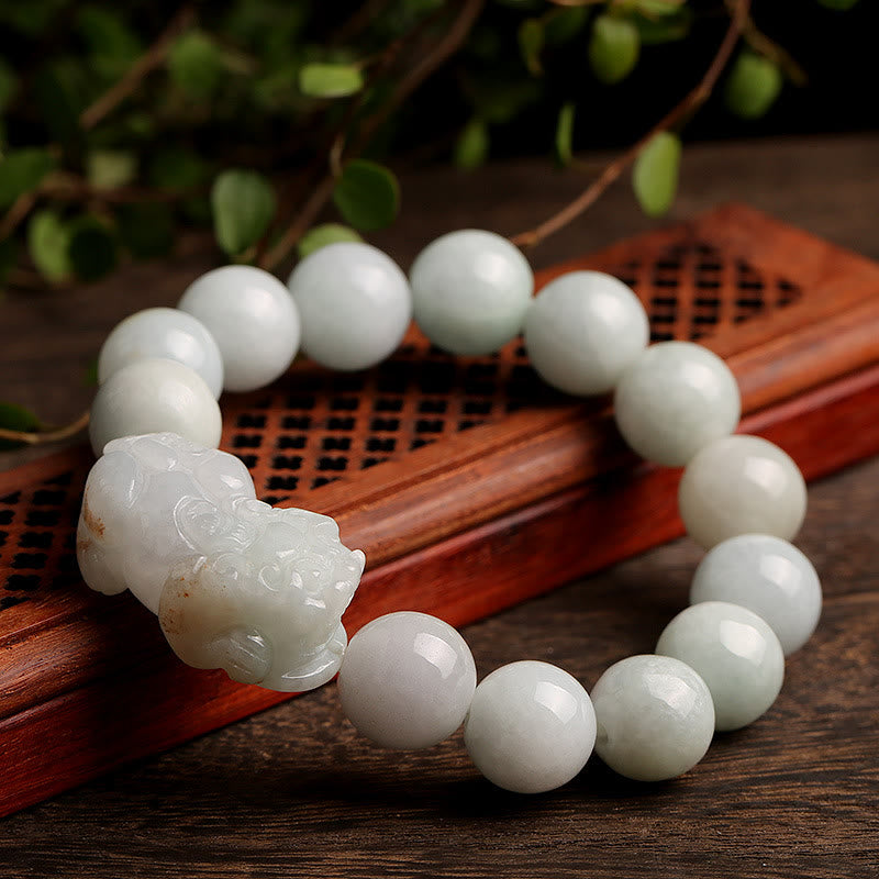 Jade PiXiu Bracelet – Close-up on carved wood tray showing PiXiu detail, prosperity protection jewelry