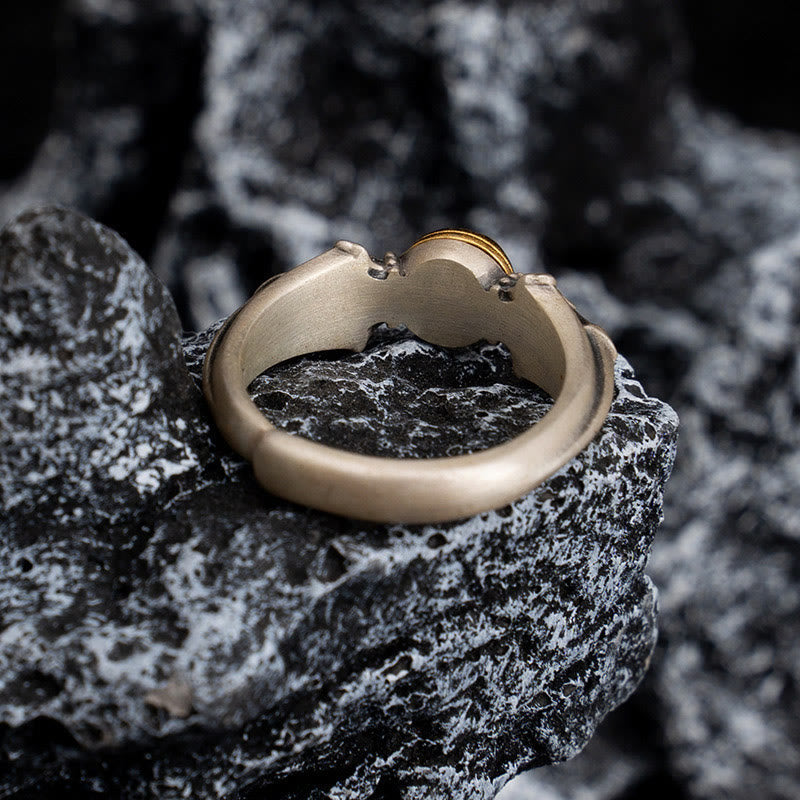 Manjusri Mantra Ring – Side angle showing gold spinner center and leaf carvings on stone, mantra ring