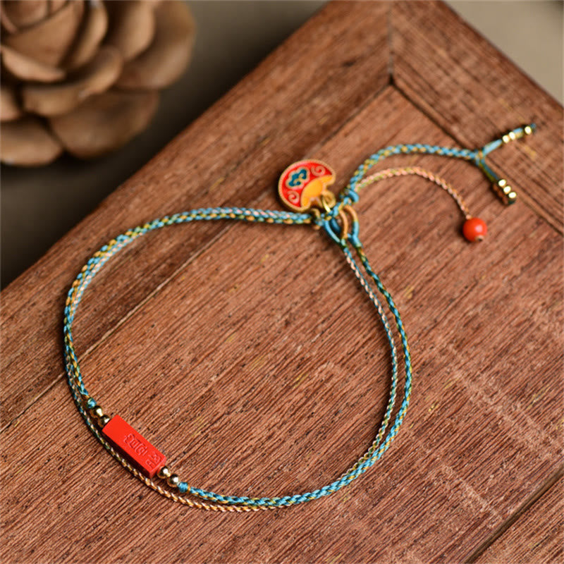 Cinnabar Braided Bracelet - Turquoise gold cord with red bead on rustic wood, bohemian bracelet