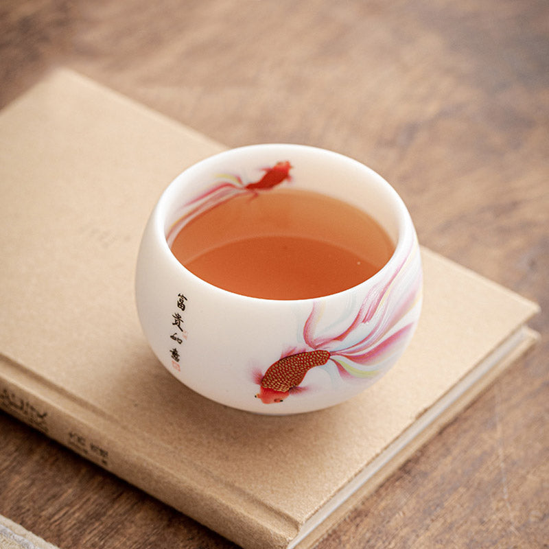 Koi Fish Porcelain Cup - pair of cups side by side showing koi fish design variation
