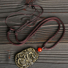Gold Sheen Obsidian Dragon Pendant – Elevated angle showing metallic gold luster across dragon scales, wealthy