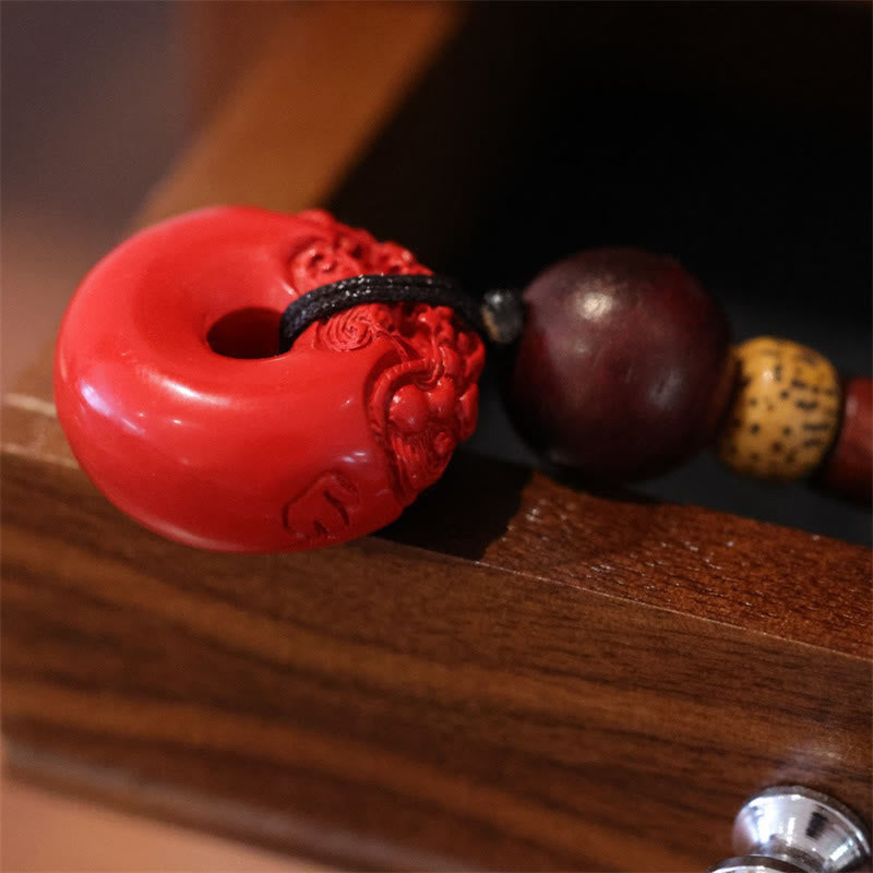 Cinnabar Peace Buckle Keychain – Close-up of red carved PiXiu detail on cinnabar buckle surface