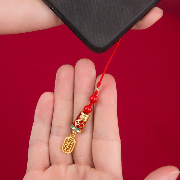 Koi Fish Cinnabar Ruyi Phone Charm – cinnabar koi fish with gold-tone ruyi and red tassel on phone case, wealth