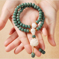 Bodhi Seed Lotus Bracelet – green seed bracelet cradled in open palms, bodhi seed protection