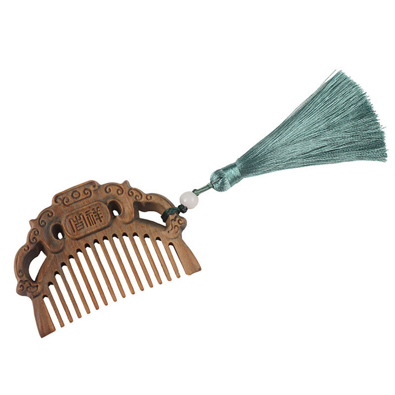 Product shot of green sandalwood auspicious cloud comb with blue tassel on white background