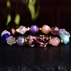 FengShui Amethyst PiXiu Luck Bracelet – colorful bead bracelet on dark surface with green plants, zen jewelry
