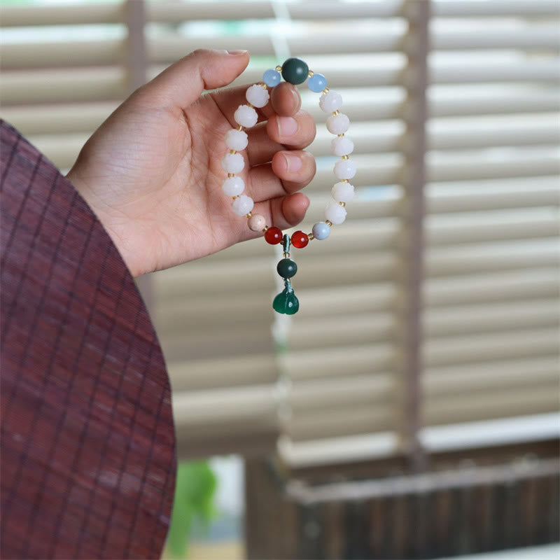 Carved Bodhi Seed Lotus Bead Peace Bracelet - in hand against window light, mindful peace