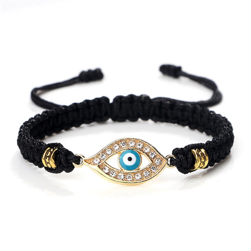 Black cord evil eye bracelet with gold turquoise evil eye crystal charm on white bg