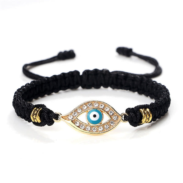 Black cord evil eye bracelet with gold turquoise evil eye crystal charm on white bg