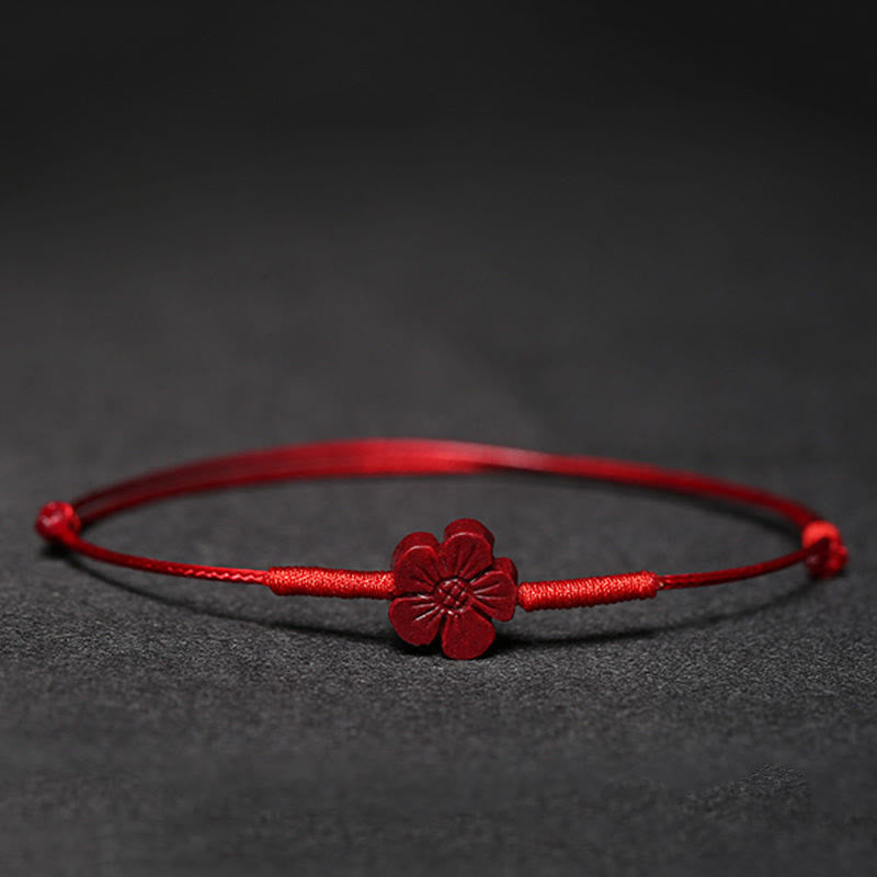 Cinnabar PiXiu Lotus Koi Fish Blessing Braid Bracelet – red cinnabar flower charm on red cord against black background, handmade lucky jewelry