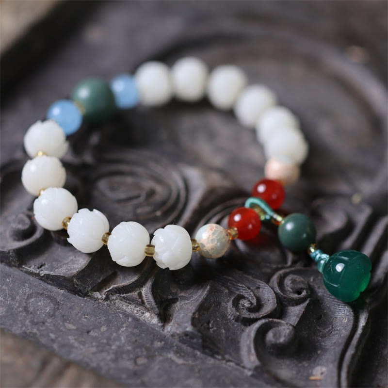 Carved Bodhi Seed Lotus Bead Peace Bracelet - on carved dark wood tray, spiritual balance