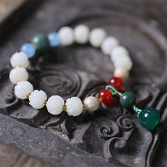 Carved Bodhi Seed Lotus Bead Peace Bracelet - on carved dark wood tray, spiritual balance