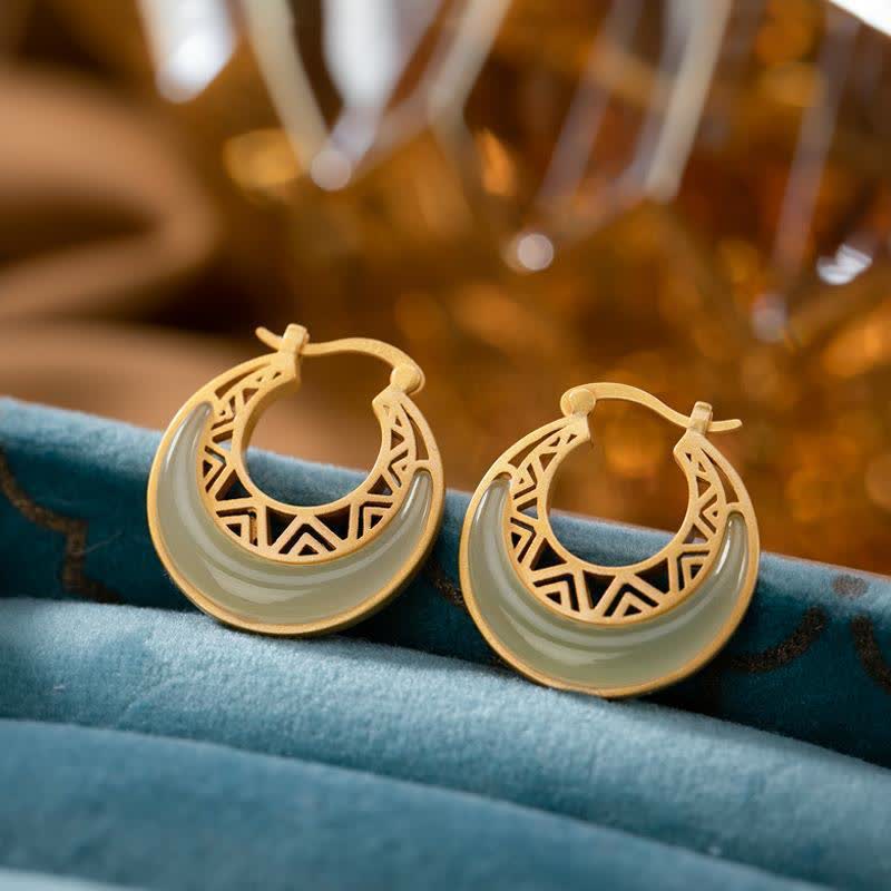 Crescent Moon Jade Drop Earrings – Gold hoop earrings with pale green jade crescent and geometric cutouts on white background product photo, frontal view