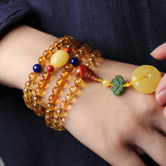 Citrine Mala Bracelet – Close-up of citrine mala on wrist showing amber peace buckle charm