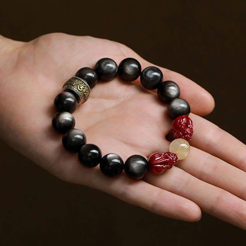 Gold Sheen Obsidian Pixiu Bracelet – palm display from above, full layout with red pixiu and golden quartz center
