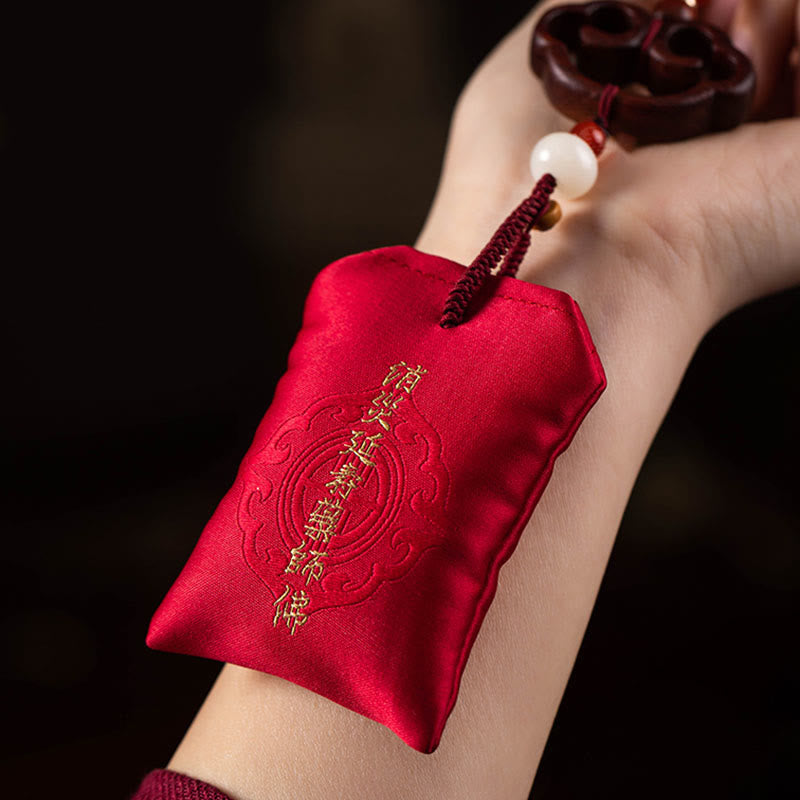 Red Sandalwood Car Hanging - Red satin amulet pouch with gold mantra embroidery held on wrist, car talisman