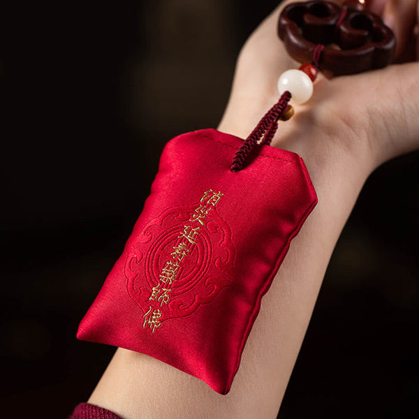Red Sandalwood Car Hanging - Red satin amulet pouch with gold mantra embroidery held on wrist, car talisman