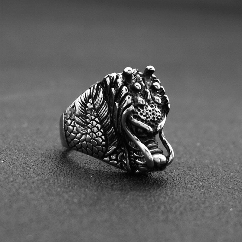 Dragon Balance Titanium Steel Ring – high-contrast dragon head with tusks on dark fabric, statement
