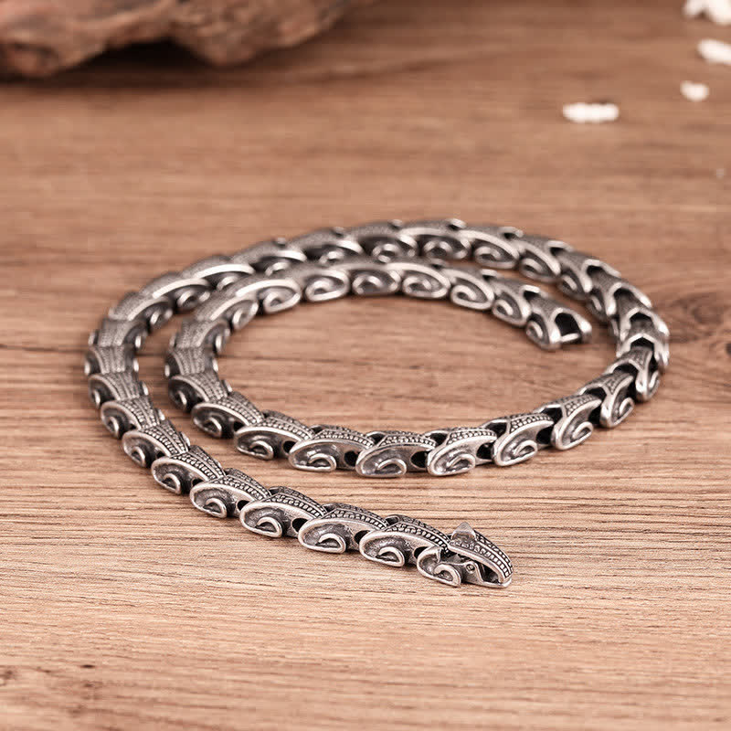 Dragon Necklace Bracelet Set - Viking-style silver chain coiled on brown wood, Strength