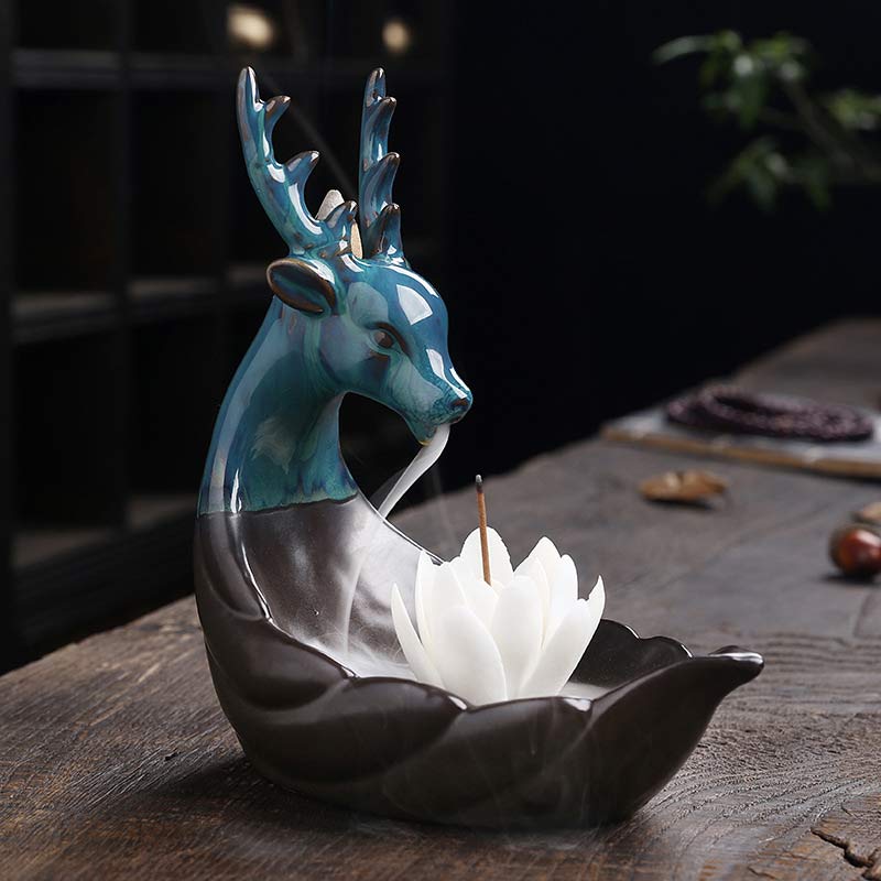 Little Deer Ceramic Lotus Incense Burner – Profile of turquoise deer with white lotus on dark wood, S-curve silhouette