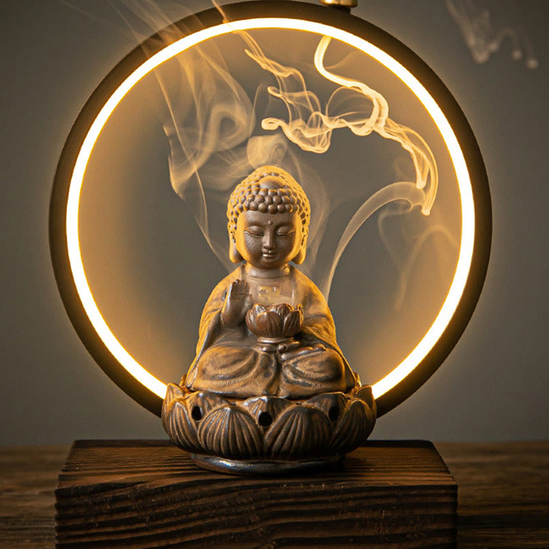Bronze-finish Buddha incense burner with LED halo and rising smoke on wood, warm amber meditation lamp