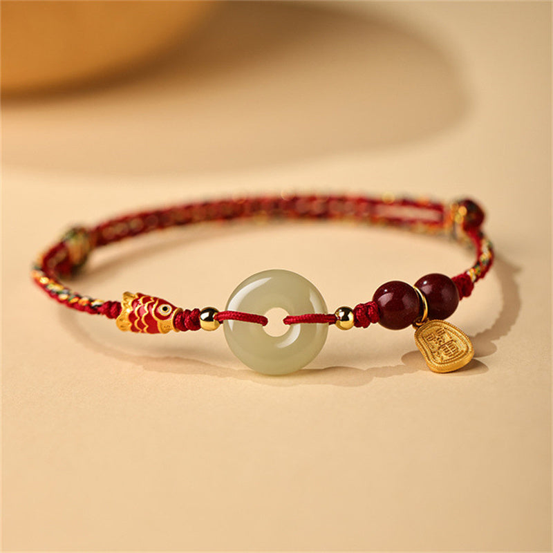 Hetian Jade Bracelet – Close-up of green jade peace buckle on silver chain, koi fish