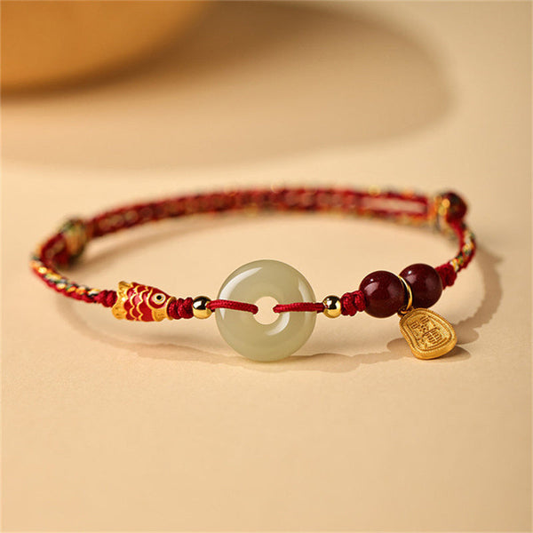 Hetian Jade Bracelet – Close-up of green jade peace buckle on silver chain, koi fish