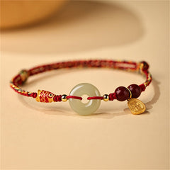 Hetian Jade Bracelet – Close-up of green jade peace buckle on silver chain, koi fish