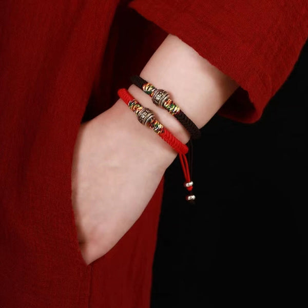 Tibetan Mantra Bracelet – Stacked red and black pair with silver engraved beads on wrist, woven bracelets