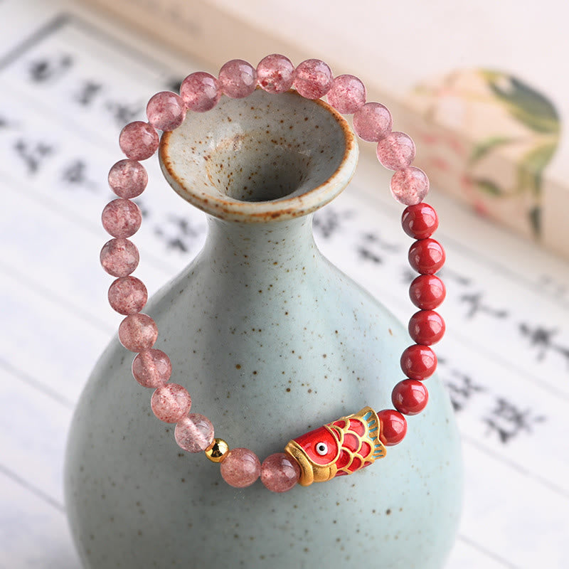 Strawberry Quartz Koi Bracelet – close-up of carved cinnabar koi fish bead with fine scale detail