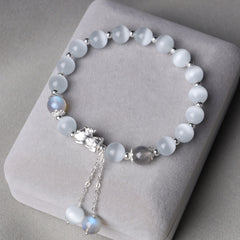 Cat's Eye PiXiu Bracelet – Gray cushion display with cat's eye moonstone beads and silver accents