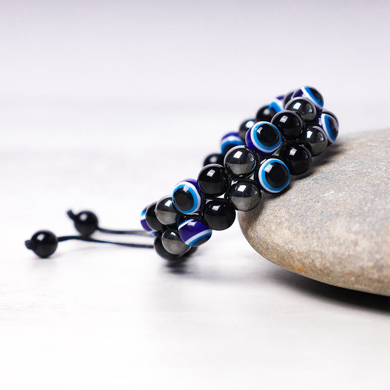 Evil Eye Tiger Eye Bracelet – multi-strand hematite black and evil eye beads on river stone display
