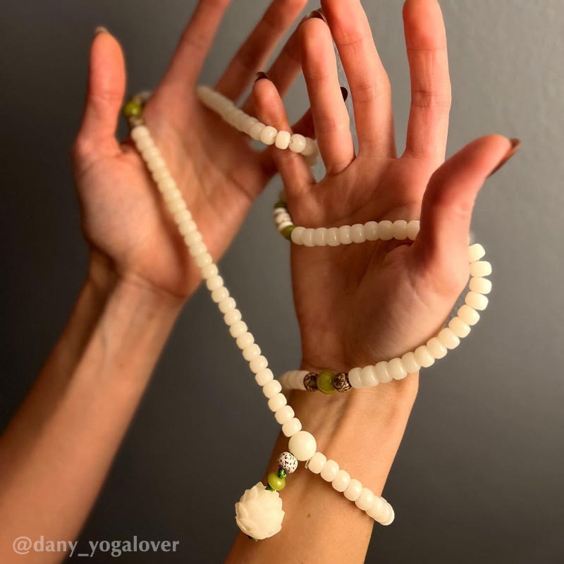 Bodhi Seed Lotus Mala - cradled in open palms with lotus pendant, reverent hand presentation, sacred