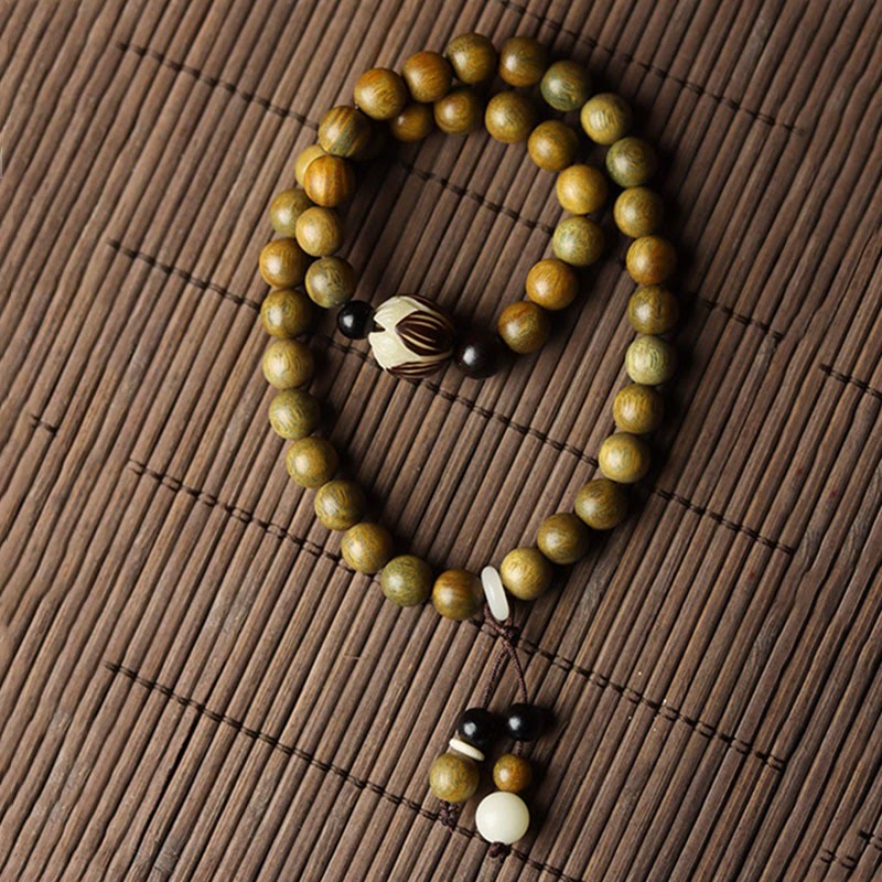 Green Sandalwood Lotus Bracelet – U-shape on bamboo mat, complete bead layout and tassel