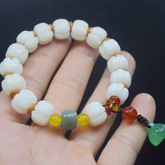 Bodhi Seed Lotus Bead Bracelet - white carved beads in palm, harmonious earth tones