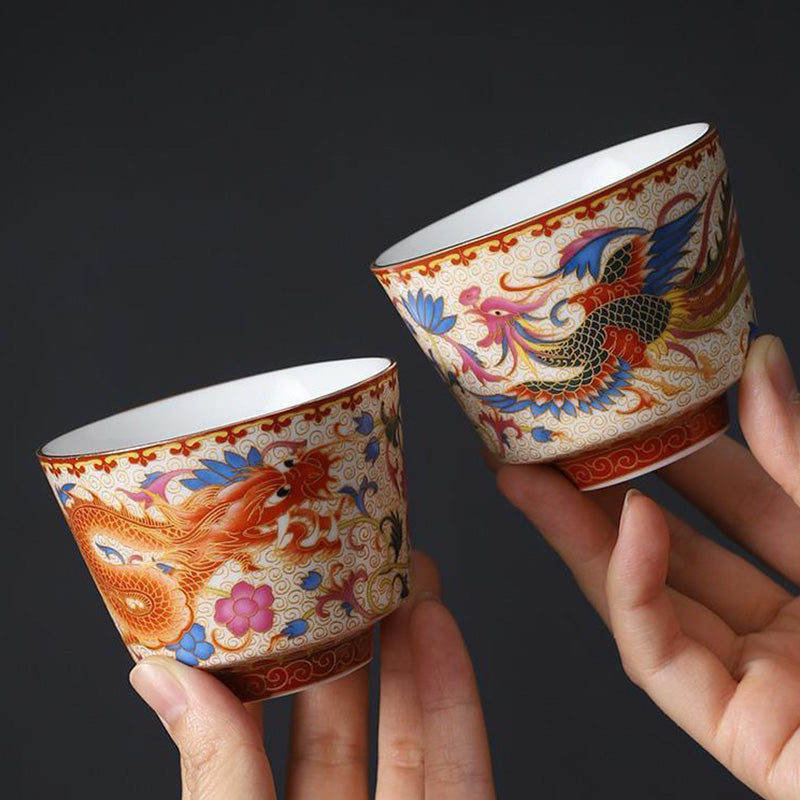 2Pcs Dragon Phoenix Ceramic Teacup Set - Paired dragon and phoenix cups held in hands, wedding gift