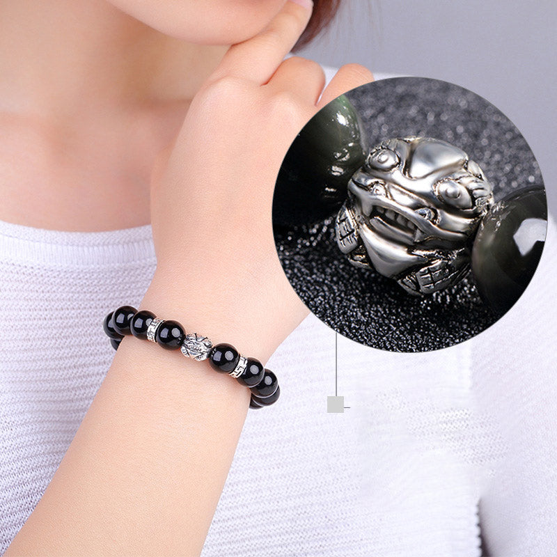 Rainbow Obsidian Bracelet – Woman wearing with magnified silver PiXiu detail inset, close-up