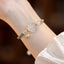 Red Agate Jade Lotus Bracelet – teal cord with frosted white crystal flower and shell charm, white bead accents, lifestyle shot