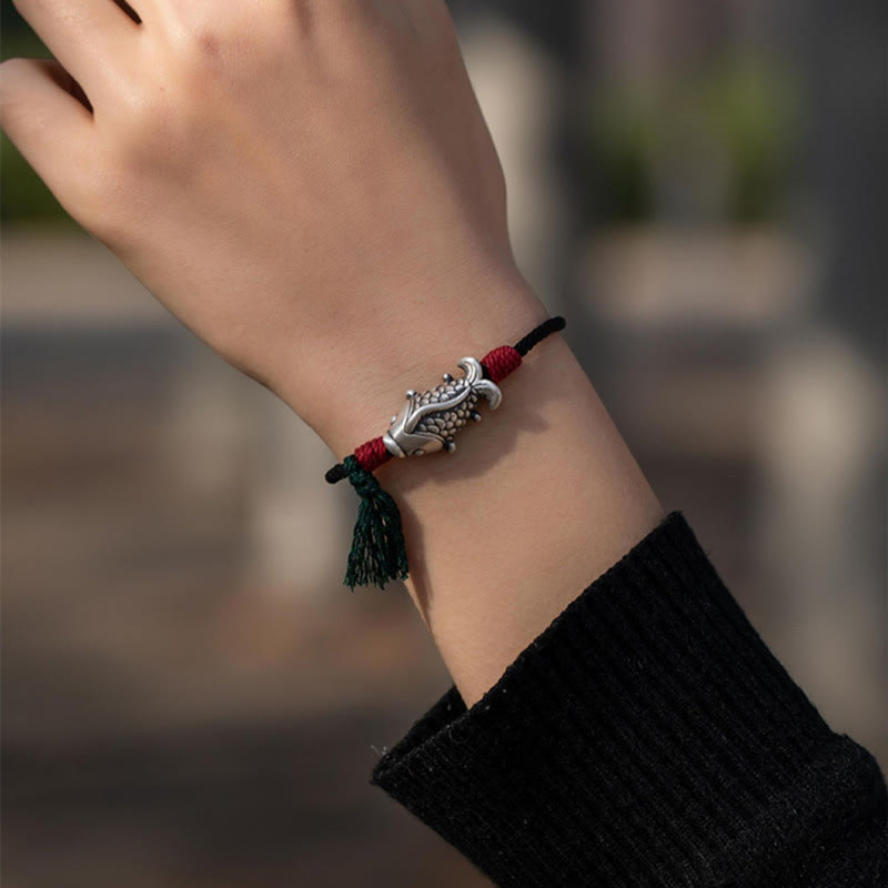 925 Sterling Silver Koi Fish Bracelet – worn on wrist outdoors, dual-color red green cord with silver koi fish charm