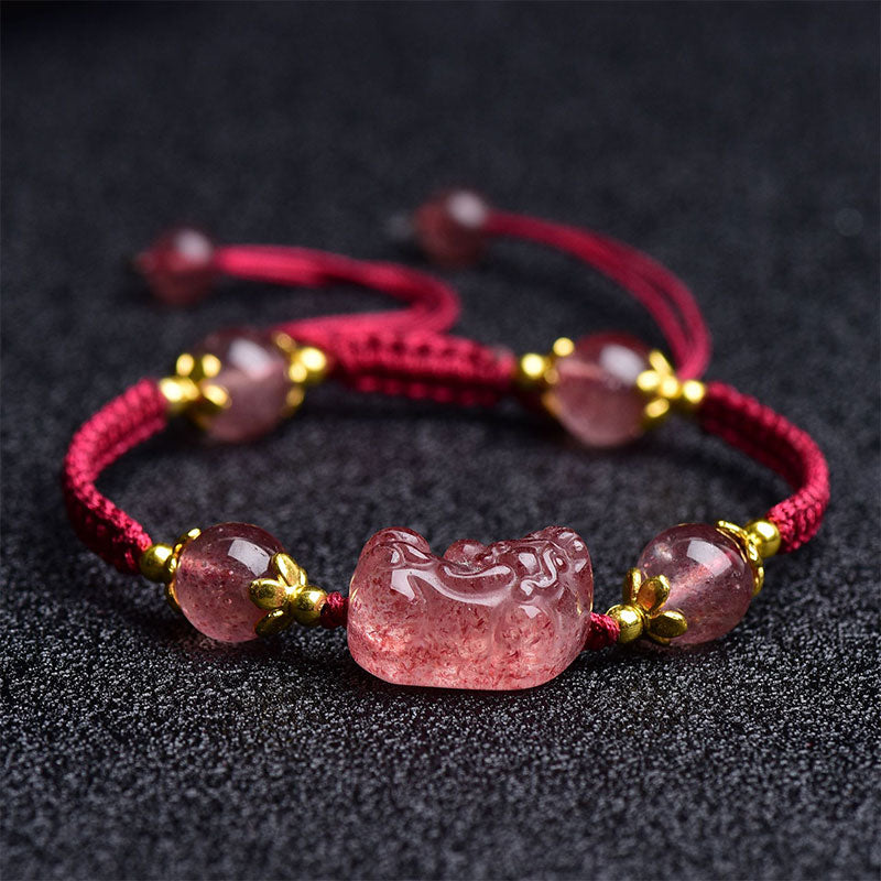 Strawberry Crystal PiXiu Charm Lucky Red String Bracelet – flat lay showing adjustable cord and strawberry quartz on dark background, crystal healing bracelet