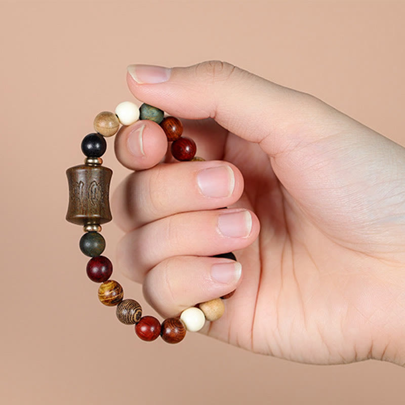 Multicolored Sandalwood Prayer Bracelet – Hand-held close-up revealing bead colors and textures