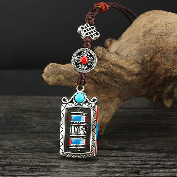 Om Mani Padme Hum Prayer Wheel Keychain – Frontal view showing endless knot and red stone medallion, Tibetan pendant