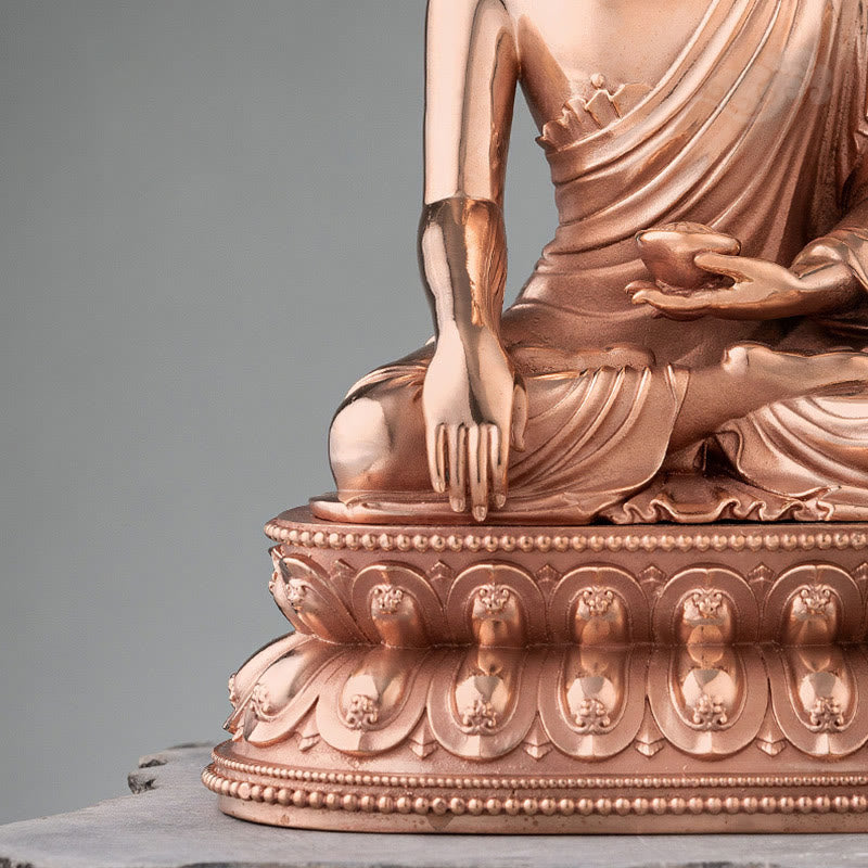Shakyamuni Copper Statue – close-up of serene face with downcast eyes and gentle smile, Buddha icon