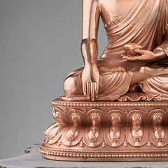 Shakyamuni Copper Statue – close-up of serene face with downcast eyes and gentle smile, Buddha icon