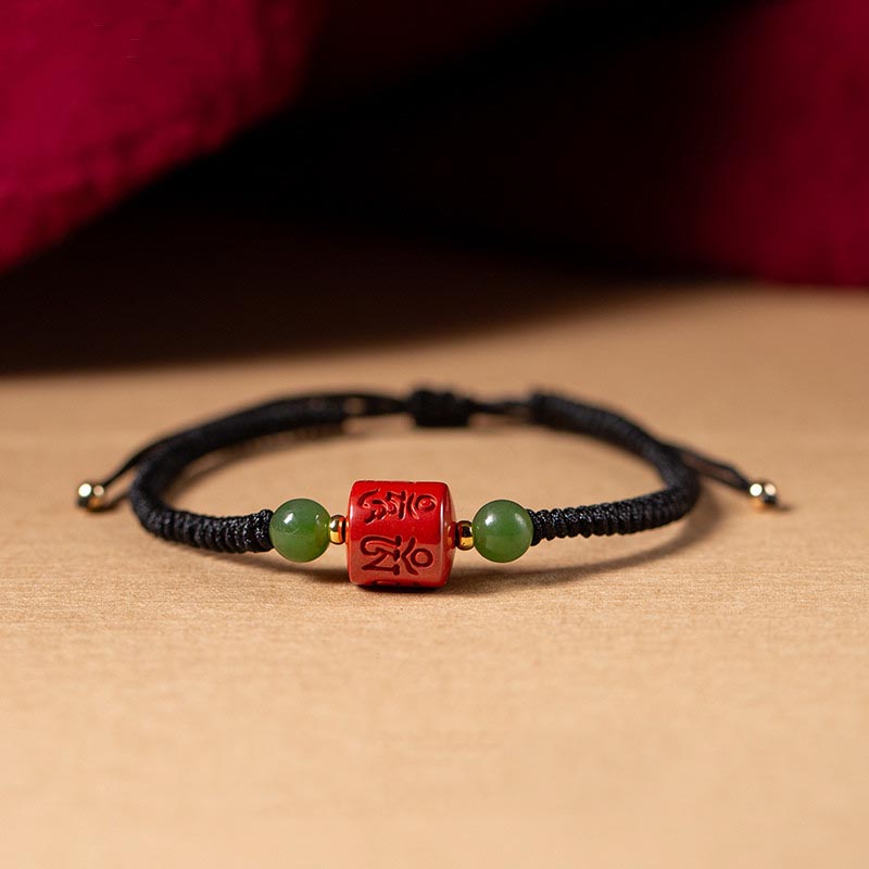Tibetan Cinnabar Braided Rope Bracelet – Black cord version with carved red bead front view, protection amulet
