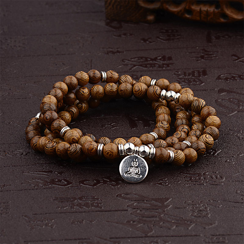 Tibetan Lightning Strike Wood Mala – coiled wrap with Buddha charm, carved wood accent, front