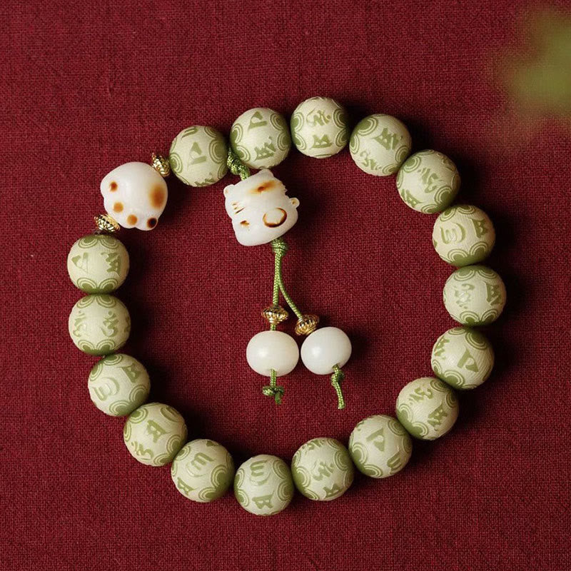 Bodhi Seed Bracelet – Green carved mantra beads with white cat charm arranged in circle, Buddhist prayer beads