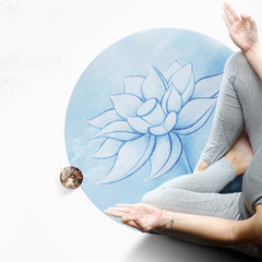 Lotus Mandala Yoga Mat – Woman meditating on round blue lotus mat with incense smoke, gray activewear, zen
